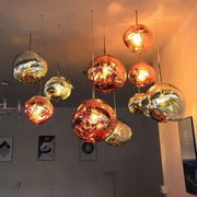 A nordic lava glass chandelier featuring spherical amber and gold lava glass pendant lights for dining room decorbites nordic lava