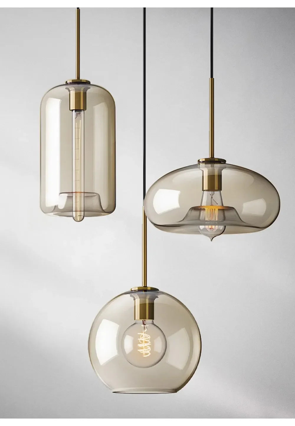 Three modern nordic led glass pendant lights with smoked glass shades and brass accents for dining room use