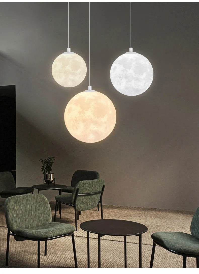 Three spherical nordic led moon pendant chandeliers illuminated in warm yellow for dining room kitchen decor