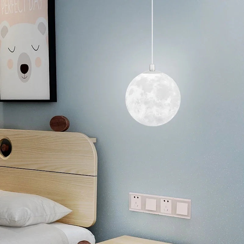 A white spherical nordic led moon pendant light with detailed moon surface design for dining room kitchen decor