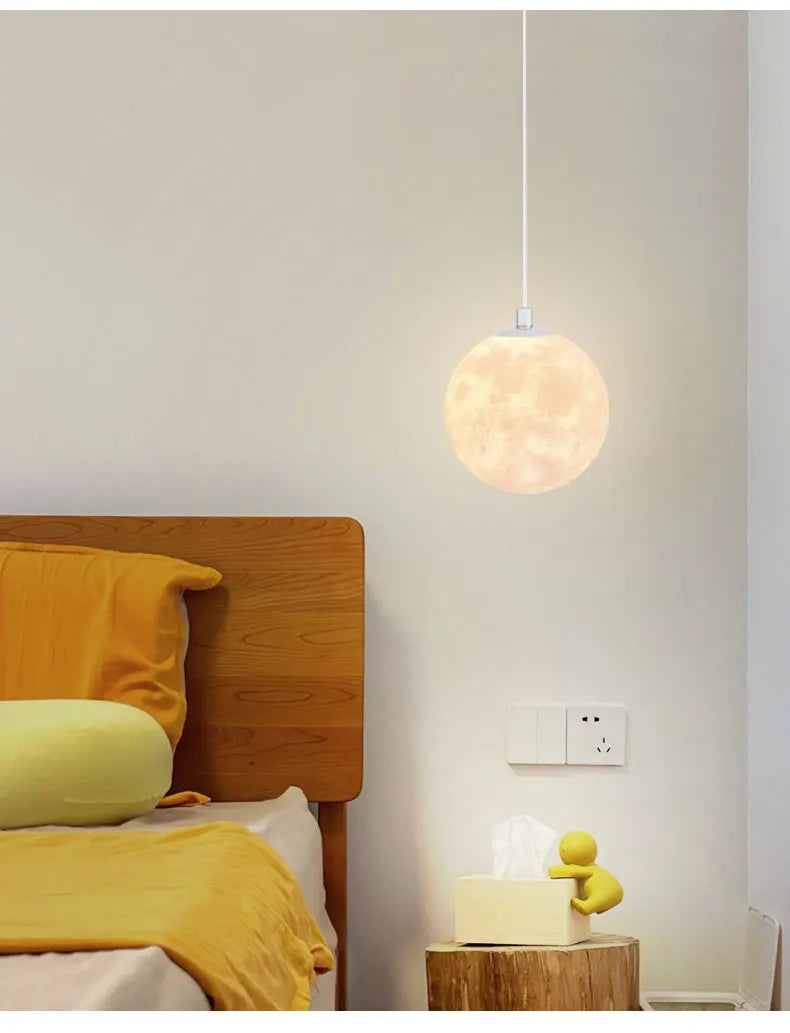 A warm glowing nordic led moon pendant light with textured surface for dining room kitchen and bar decor