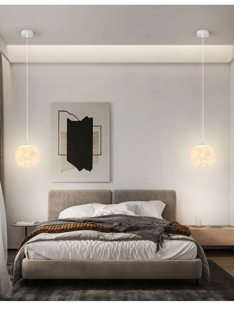 Two spherical white nordic led moon pendant chandeliers with soft glow hanging above a bed for dining room kitchen use