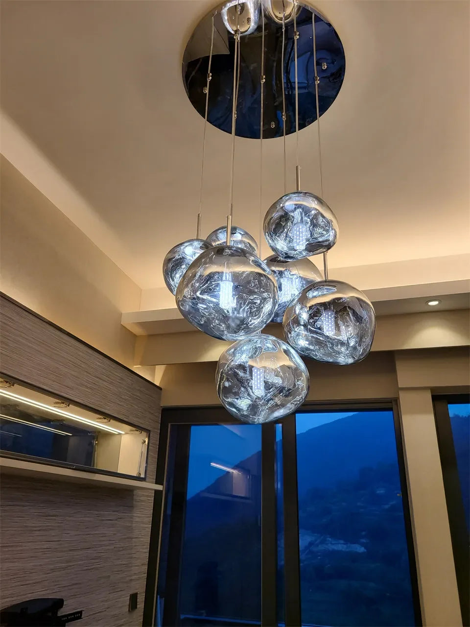 Modern chrome-finished spherical pendant light with reflective glass globes for bedroom and living room lighting