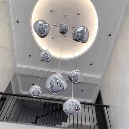 Modern chrome-finished liquid metal pendant chandelier with irregular reflective globes for indoor lighting in living spaces