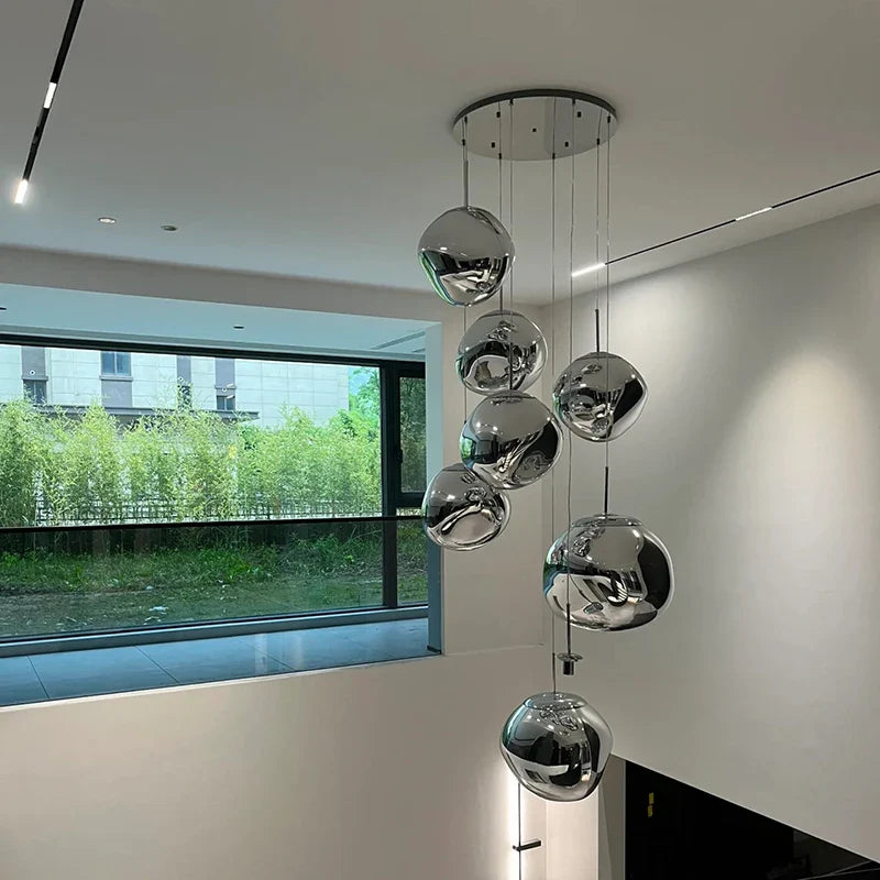 A modern chrome-finished spherical nordic led pvc pendant light with sleek minimalist design for living and dining rooms
