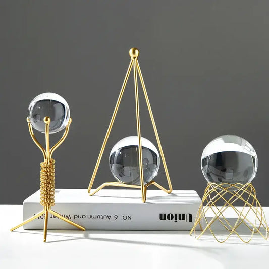 Three gold-toned metal stands with clear reflective crystal balls for nordic light luxury crystal ball crafts decor