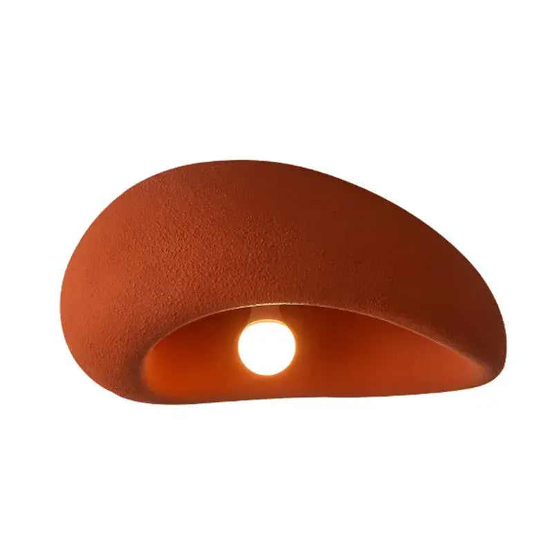 Terracotta ceramic wall sconce with matte finish and smooth curves complements nordic ceiling light for bedroom