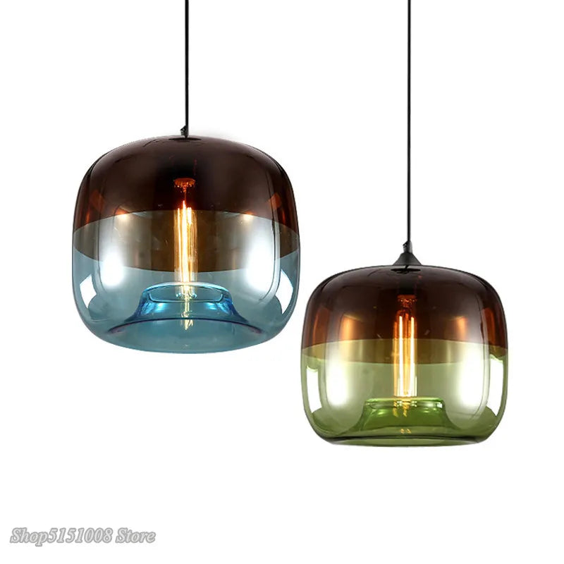 Two nordic modern apple pendant lights with rounded gradient glass shades in brown blue and brown green with filament bulbs