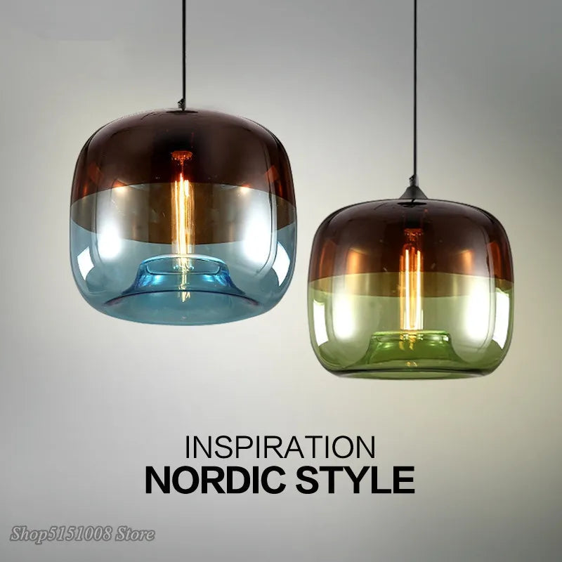 Two nordic modern apple pendant lights with rounded brown to blue and brown to green gradient glass shades and exposed bulbs