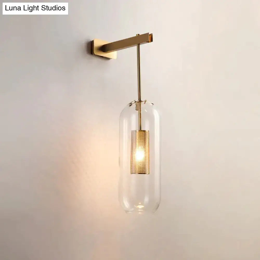 A modern nordic decor brass wall sconce with a clear glass lampshade and textured gold mesh for bedroom lighting