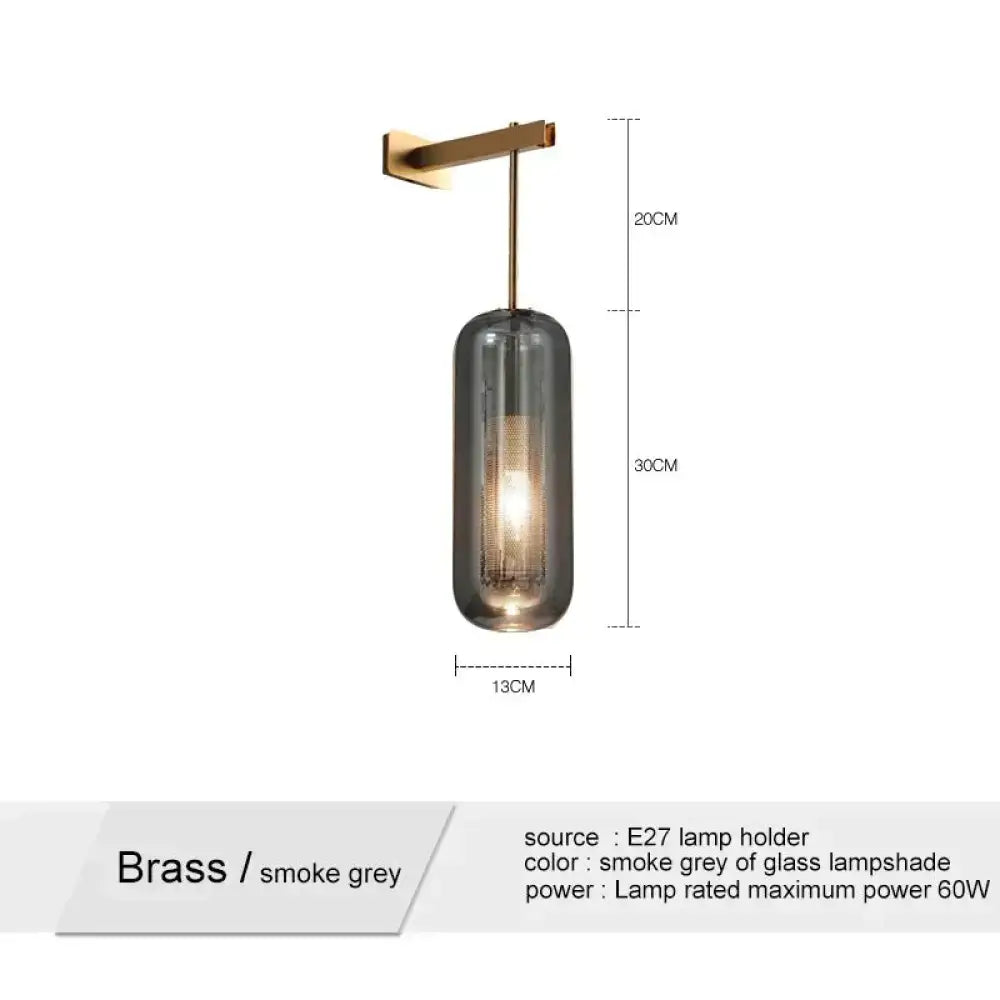 A nordic modern decor brass wall lamp with a sleek cylindrical smoke grey glass lampshade for bedroom modern decor
