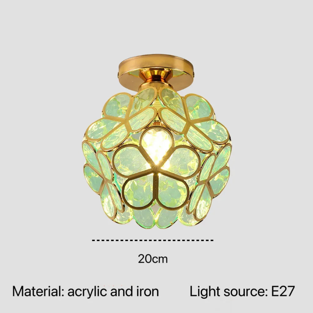 A spherical nordic modern pendant lamp with golden iron base and translucent green acrylic petals in floral design