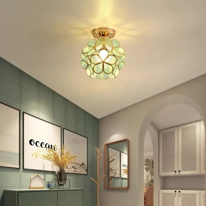 Nordic modern petal acrylic pendant lamp with gold tone and translucent green glass floral design for bedroom and foyer lighting