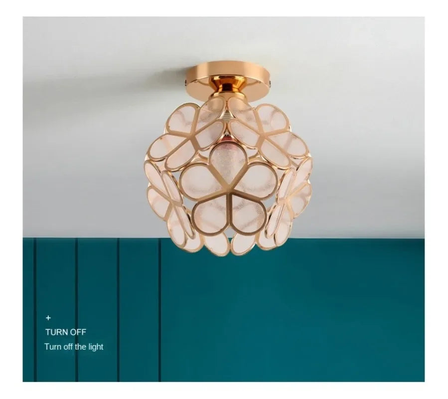 A delicate gold-toned nordic modern pendant lamp with translucent petal acrylic panels for bedroom and restaurant lighting