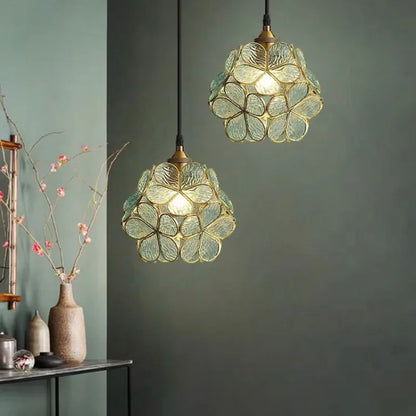 Two elegant translucent green acrylic petal pendant lamps with floral design and brass accents for modern lighting