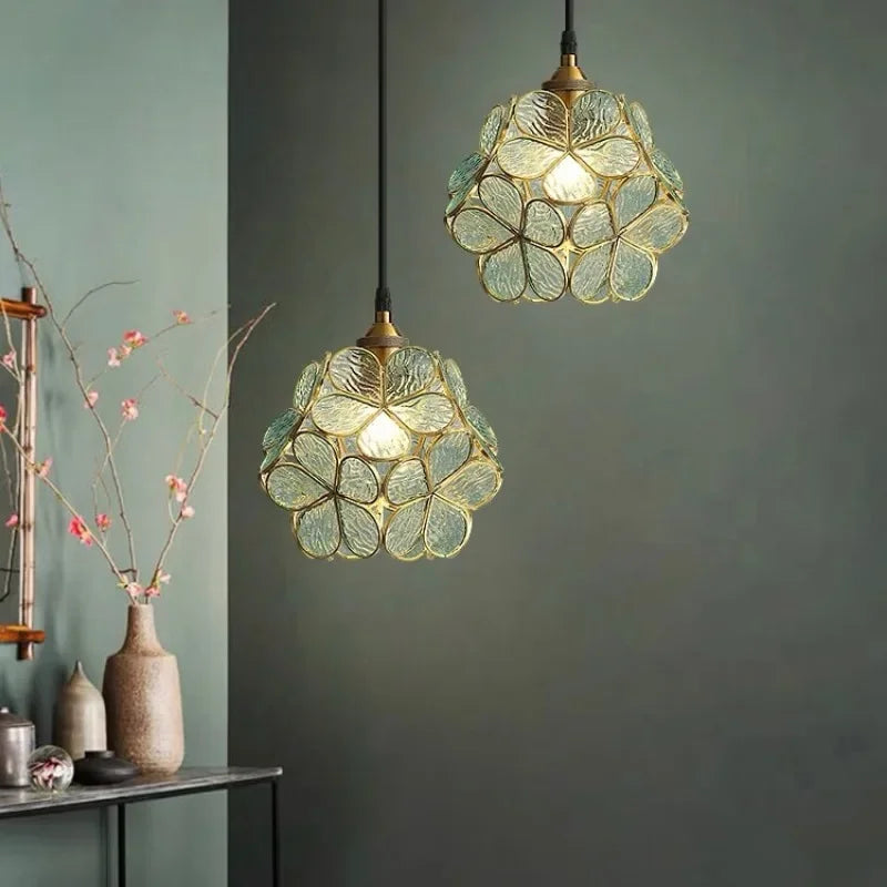 Two elegant translucent green acrylic petal pendant lamps with floral design and brass accents for modern lighting