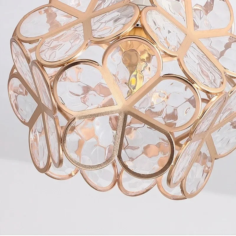Gold-toned Nordic modern petal acrylic pendant lamp with clear textured glass panels in floral pattern for bedroom lighting