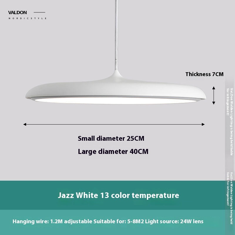 White pendant light with a modern design and adjustable hanging wire.