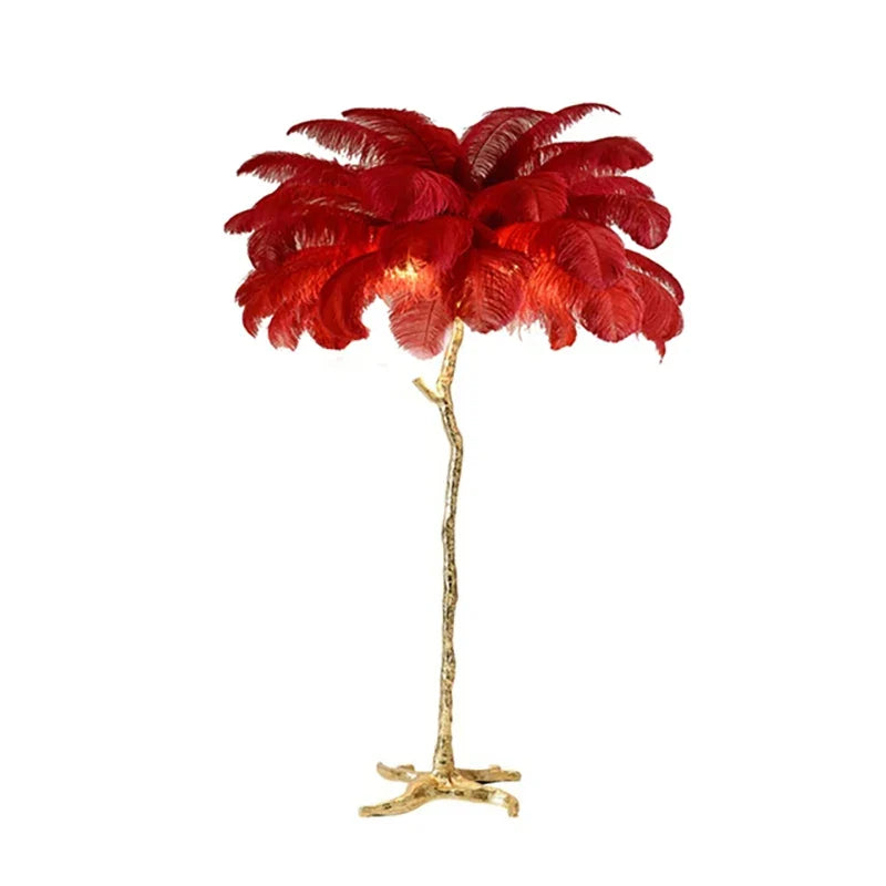 A striking red feather floor lamp with a golden tree-like stand ideal for living room and bedroom decor lighting