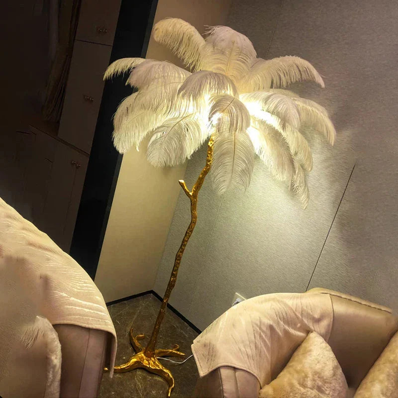 A tall elegant floor lamp with golden metallic base and white ostrich feathers for living room decor