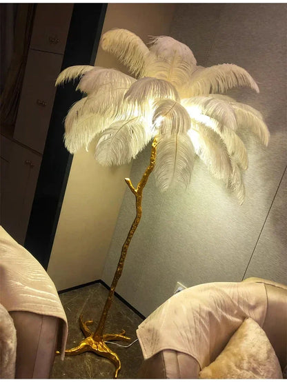 Luxurious floor lamp with golden branch base and white ostrich feathers ideal for living room and bedroom decor