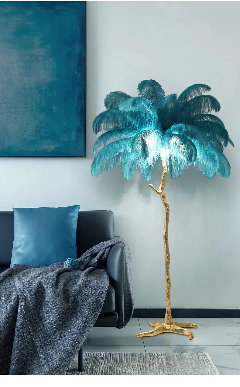 A tall nordic feather floor lamp with golden metallic base and teal ostrich feathers for living room decor