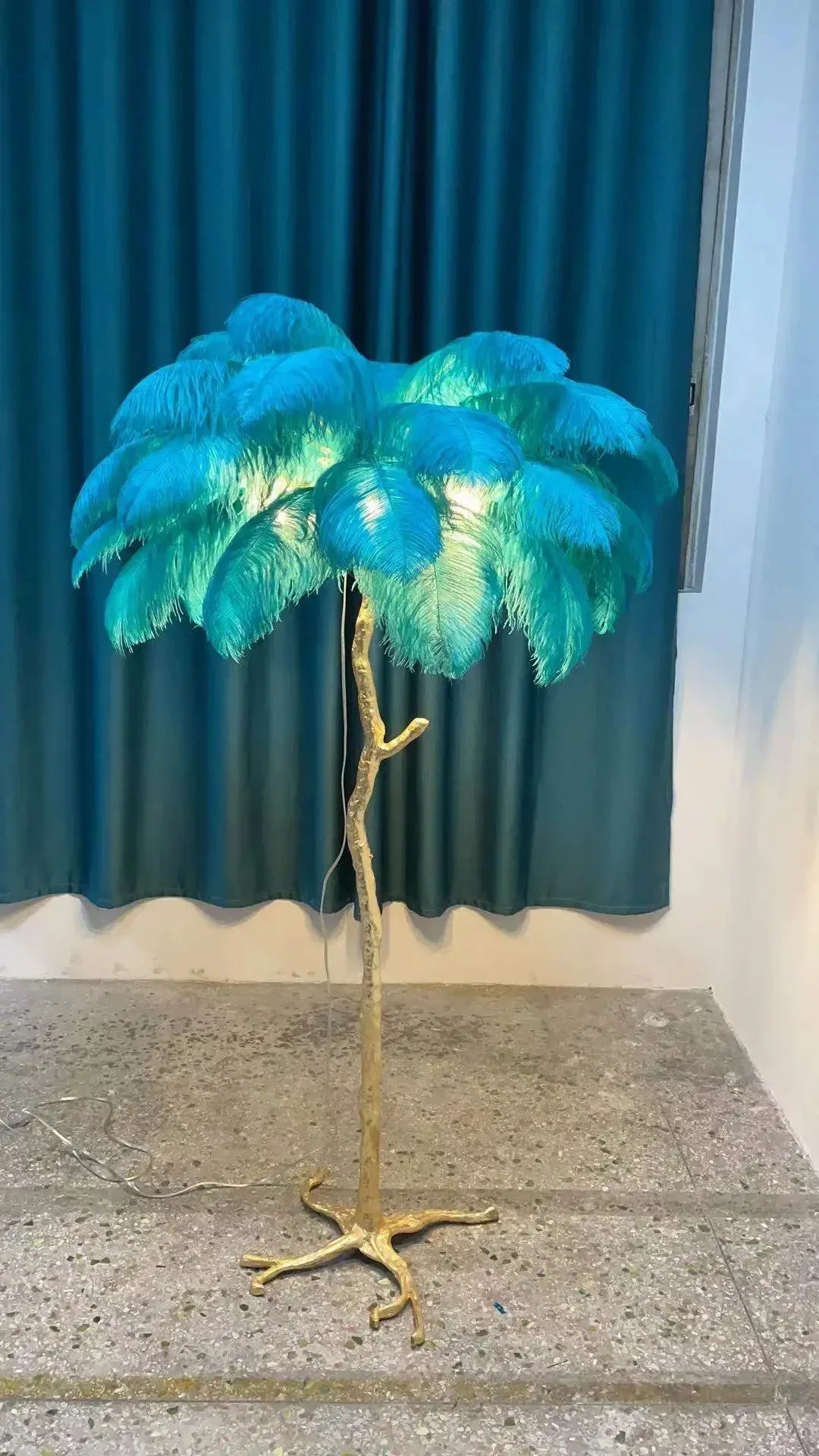 Vibrant turquoise feather floor lamp with golden tree-like stand for living room and bedroom decor lighting