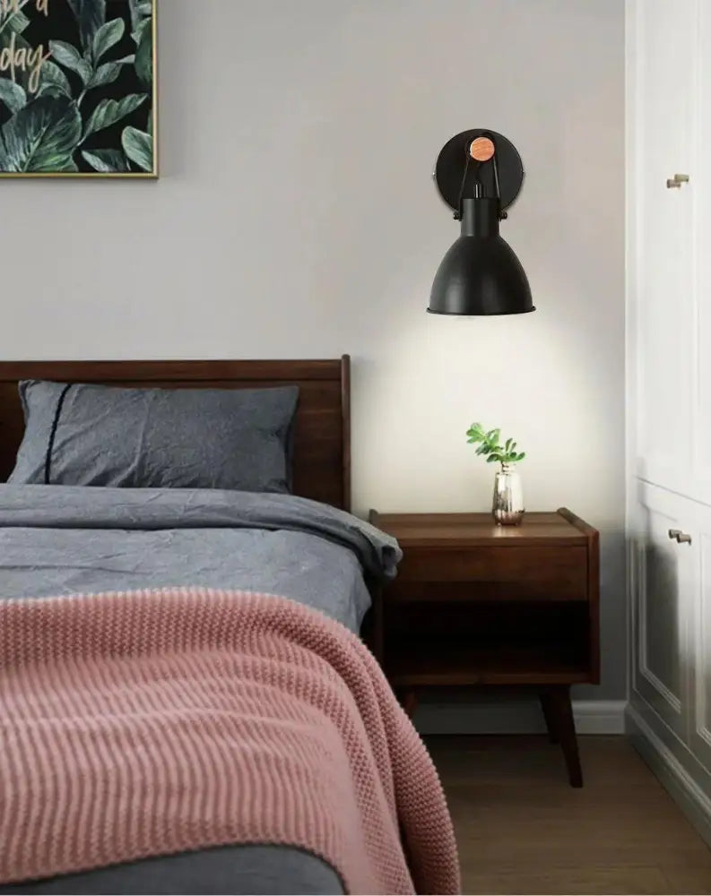 Nordic plug-in wall sconce in black finish with matte industrial style and copper-colored accent for elegant lighting