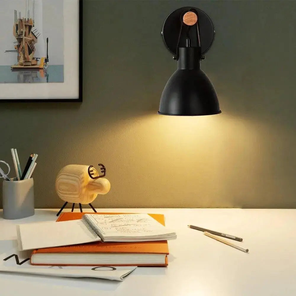Black finish nordic wall sconce with matte finish and wooden accent on algunda plug mounting plate