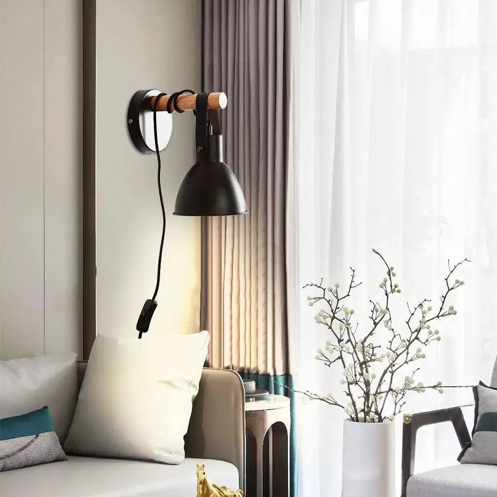 Black metal wall sconce with wooden handle and cord switch featuring nordic plug in black finish algunda plug