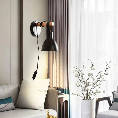 Black metal wall sconce with wooden handle and cord switch featuring nordic plug in black finish algunda plug