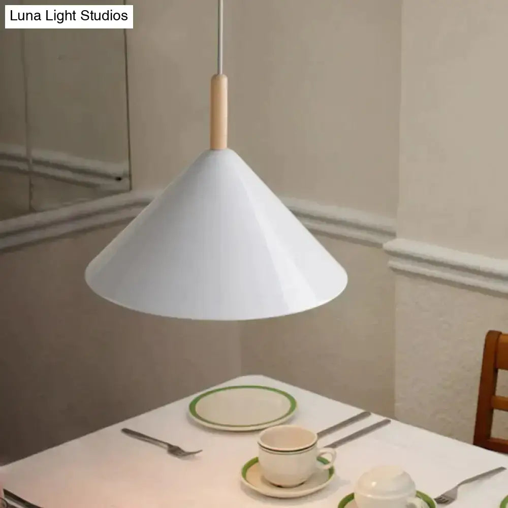 Nordic simple kitchen pendant light with a matte black conical shade and wooden stem hangs above dining table
