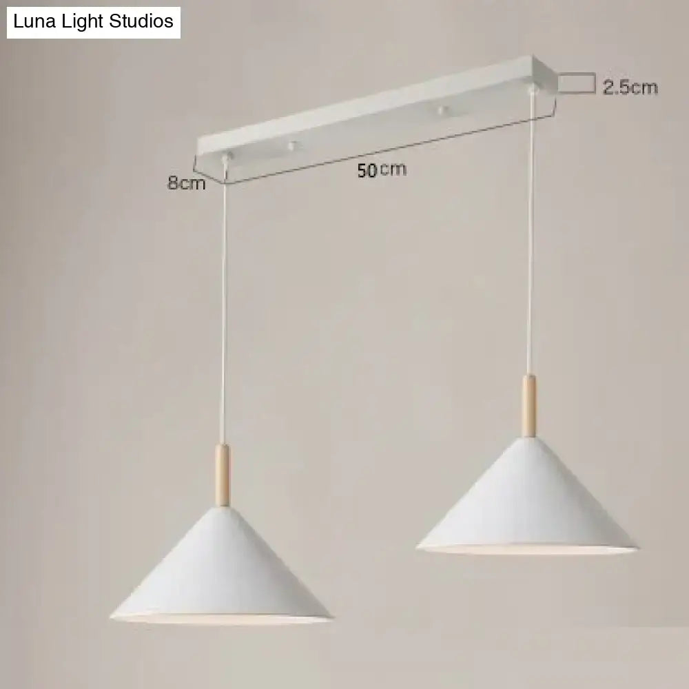 White conical pendant light with wooden accents hanging from a white mount for nordic simple kitchen use