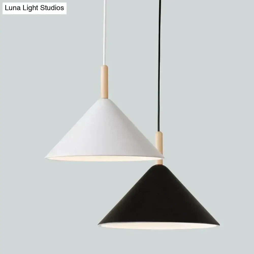 Two minimalist nordic simple kitchen pendant lights in matte black and white with wooden accents and conical shape