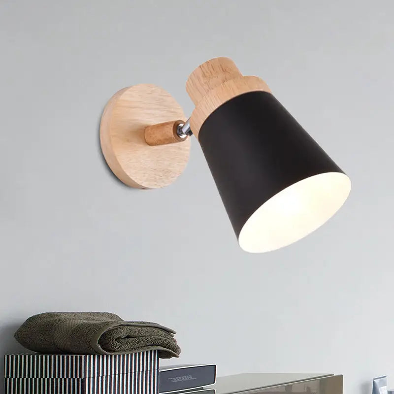 Nordic style wall light with a natural wood base and black matte coolie shade for baby room lighting