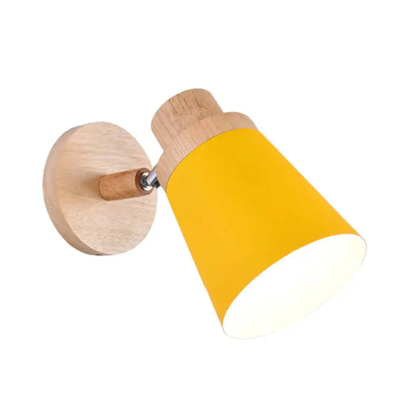A nordic style wall light with a natural wood base and yellow coolie shade for baby room inch fixture