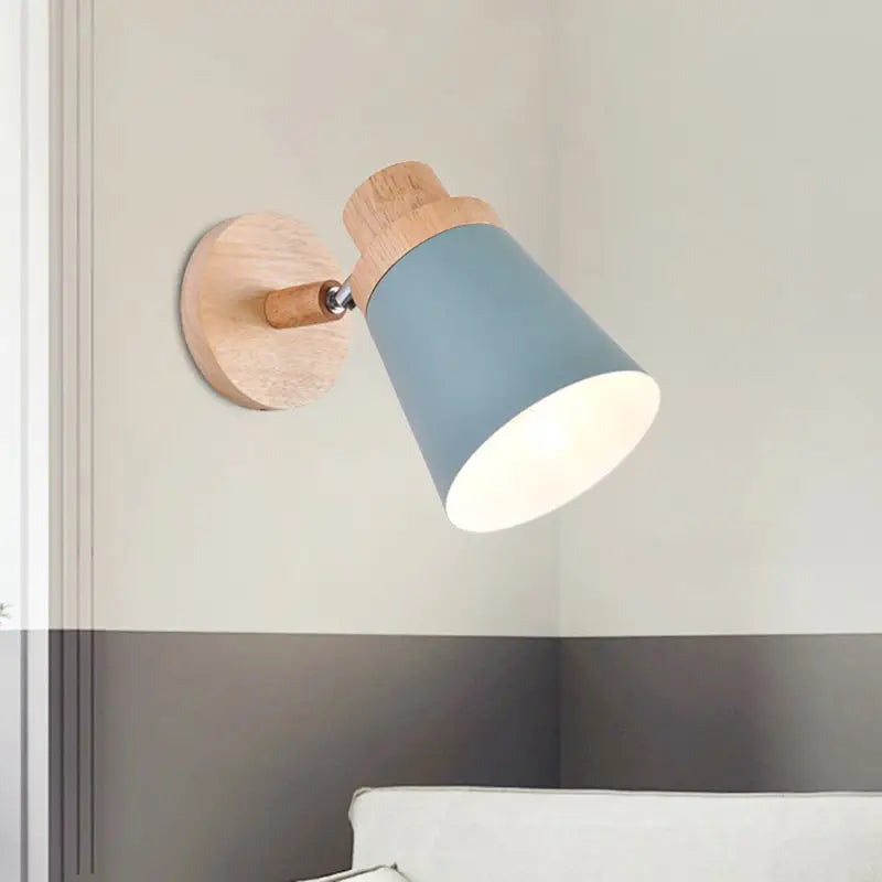 Minimalist nordic style wall light with light blue coolie shade and natural wood accents for baby room