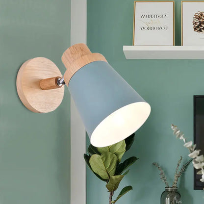Nordic style wall light with blue matte coolie shade and natural wood base for baby room lighting