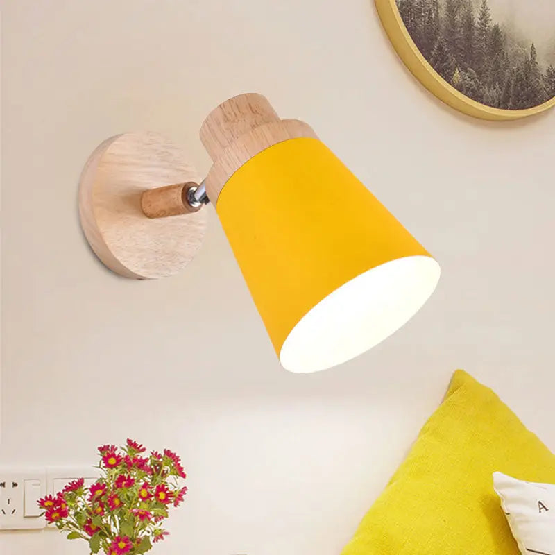 Bright yellow conical coolie shade wall light with natural wood accents in nordic style for baby room lighting