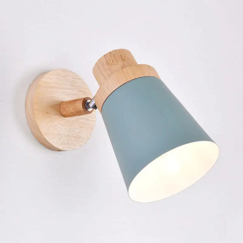 Nordic style wall light with matte teal coolie shade and natural wood accents for baby room lighting