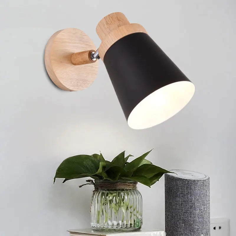 Black conical nordic style wall light with natural wood base and adjustable arm featuring a coolie shade for baby room