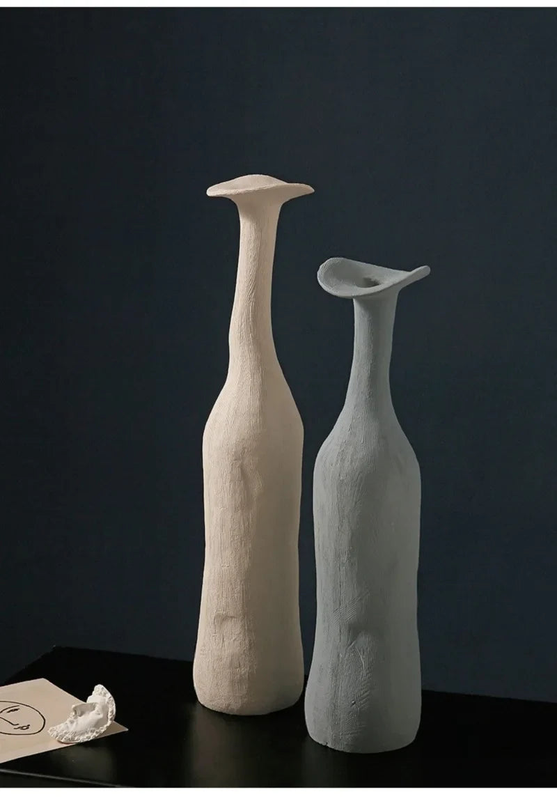 Two minimalist ceramic vases in creamy off-white and soft gray with slender necks for nordic modern home decoration