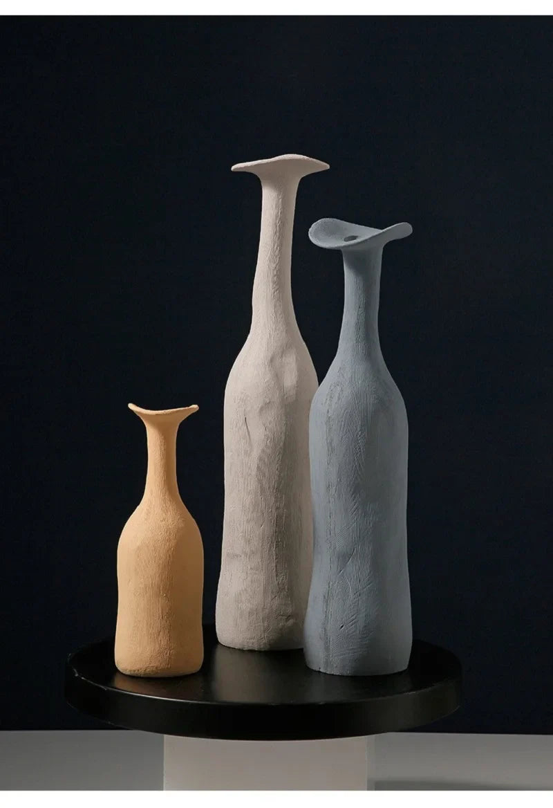 Three handcrafted ceramic vases in beige off-white and light blue with textured surfaces for modern Nordic home decoration