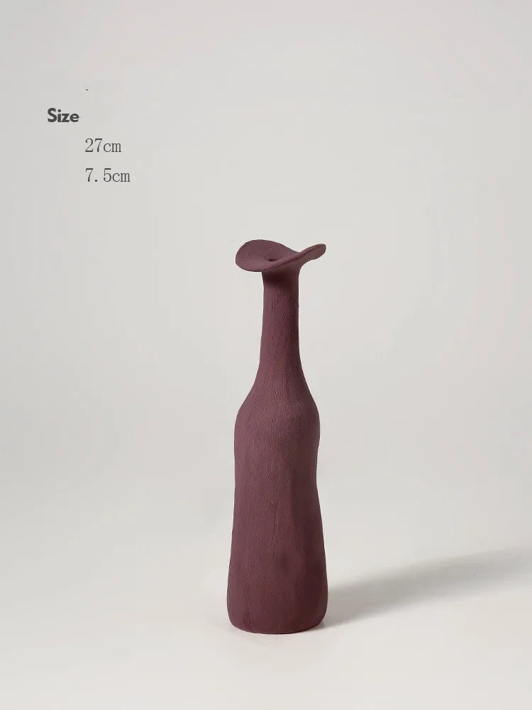 A sleek matte burgundy ceramic vase with a slender neck and sculpted top for modern Nordic home decoration