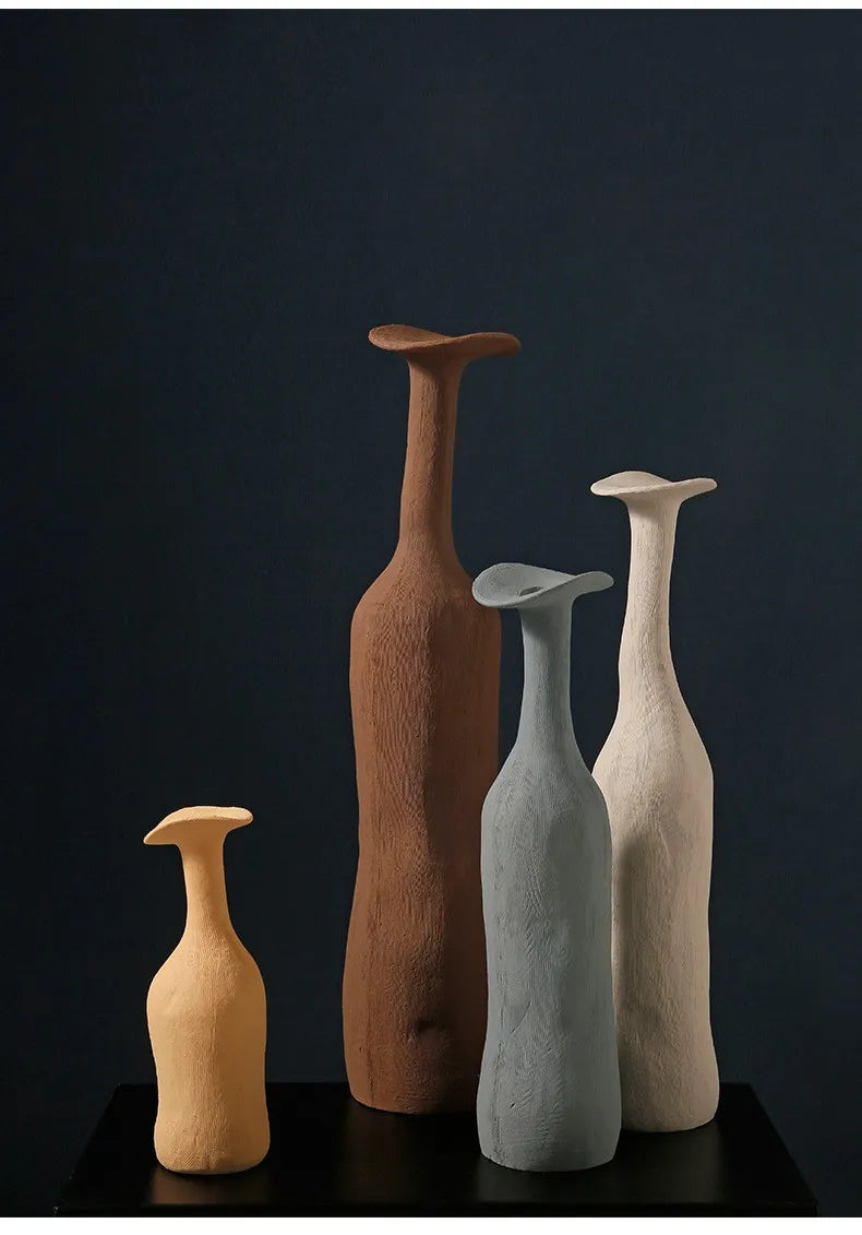 Four handcrafted ceramic vases in morandi earthy tones with unique heights and textured surfaces for modern home decoration