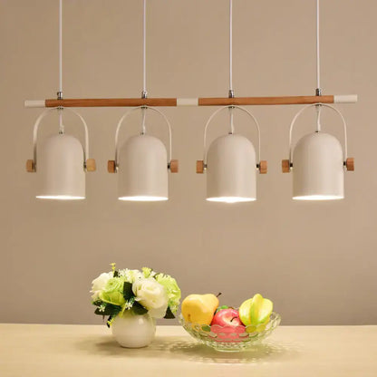 Modern white DecorBites™ Nordic style triple metal pendant light with wooden accents and adjustable dome shade above table