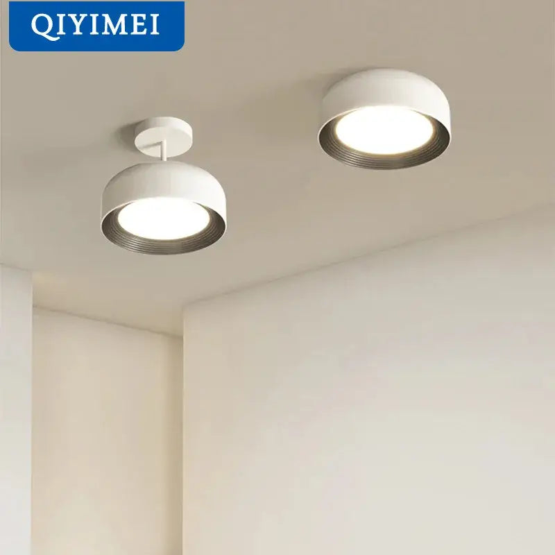 Nordic style white and silver circular chandeliers with sleek ceiling-mounted spotlights for dining room lighting decorbites nordic style