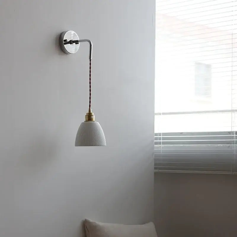 White ribbed ceramic led wall light with brass fixture and dark braided cord from decorbites ceramic led collection