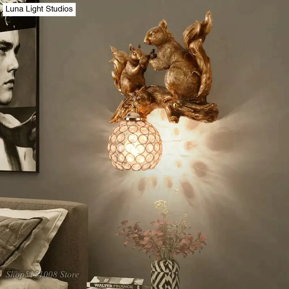 Nordic vintage style resin wall lamp with a golden squirrel design and faceted glass globe shade for bedroom lighting