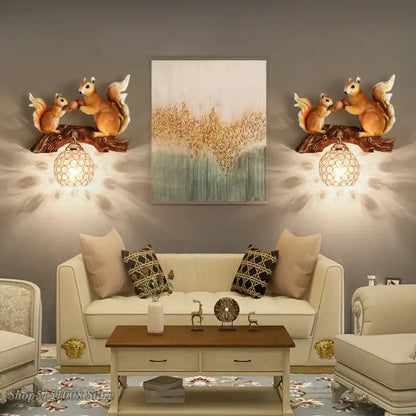 Golden squirrel wall lamp with vintage style resin and warm-toned glass globes in nordic vintage style design